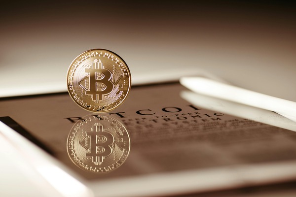 Trader showing a crypto exchange trading terminal on a laptop